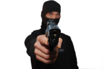 A man wearing a hood aiming a gun with white background