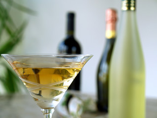 Martini glass and three wine bottles