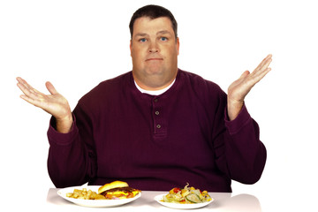 man thinking what to eat between a cheeseburger meal and a salad