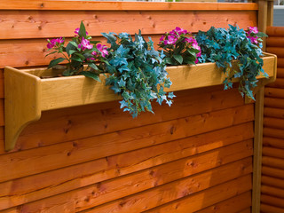 Classical planter flowerpot on a garden fence