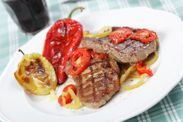 Beef steaks with vegetables and red wine