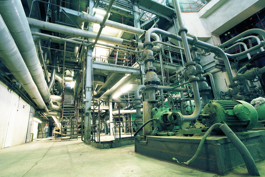 Equipment, cables and piping as found inside of a modern industr