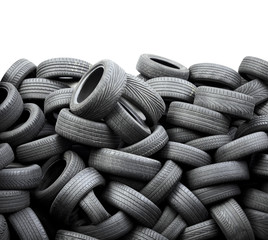 Wall of old car tires on white background