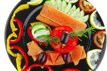 salmon slices on black plate