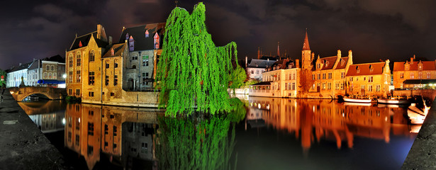 Panorama of old buildings and canal  in th night Brugge