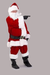 Santa Claus pointing to blank space