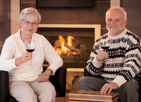 Happy senior couple having wine