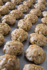 tray of cooked meatballs on a baking sheet