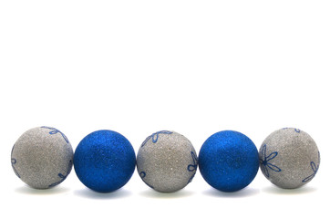 row of blue and silver christmas balls isolated on white