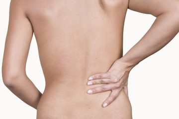 Woman massaging lower pain back