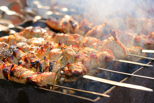 The shish kebab on skewers is fried on a brazier