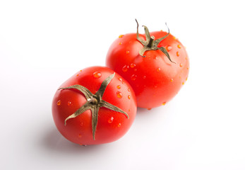 Two tomatoes on white