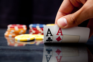 Male hand showing two aces