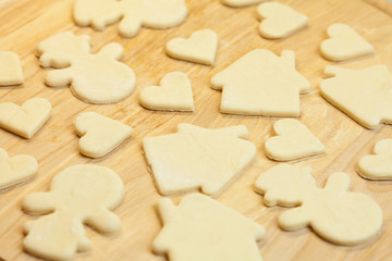 cut in the dough snowman, heart, and  house