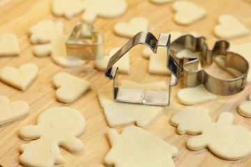 cut dough snowman, house, heart, and forms for cookies