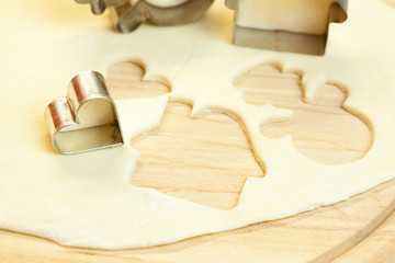 cut dough snowman, house, heart, and forms for cookies