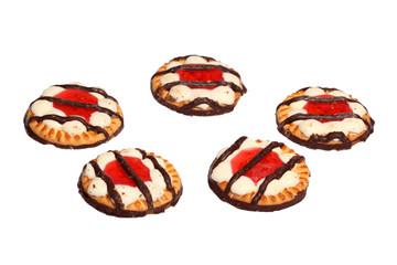 Biscuits cookies with jelly and striped chocolate on top