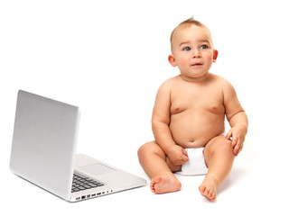 Surprised baby boy using a laptop computer
