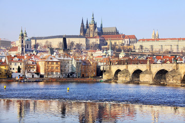 Fototapeta na wymiar First Snow in Prague, gothic Castle with the Charles Bridge in
