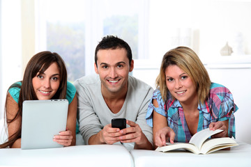 Group of friends laying in sofa at home