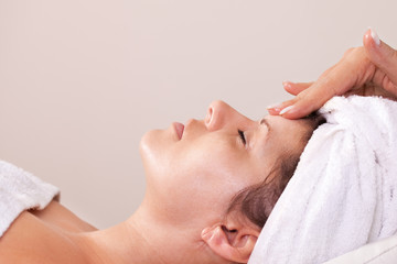 Obraz na płótnie Canvas Young beautiful woman getting facial massage