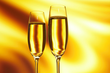 Glass of champagne against golden background