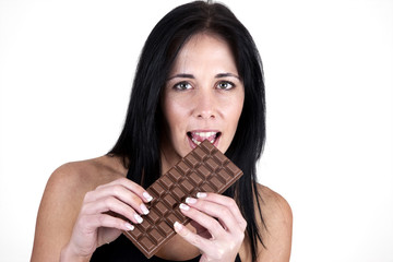 Woman biting into large chocolate bar