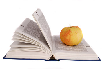 apple and glasses on the book