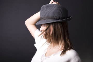 Portrait of a young fashionable girl in hat