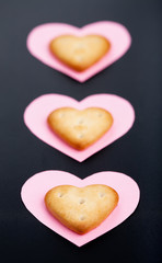 Naklejka na ściany i meble Three crackers on pink paper hearts