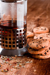 french press with hot tea and fresh baked cookies