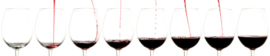 red wine pouring into glass, isolated on white background