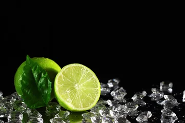 Wall murals Slices of fruit Lime on a black background