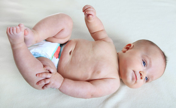 Baby Girl Laying On Back And Wearing A Diaper