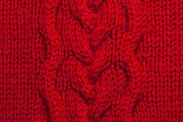 Red knitting background of handmade woolen pattern