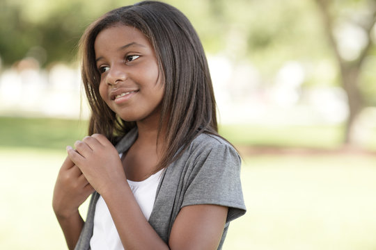 Child Playing With Her Hair In The Park