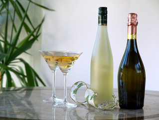Crystal martini glasses with two wine bottles on the table