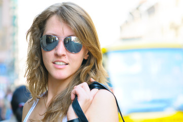 young smiling woman on bright city street