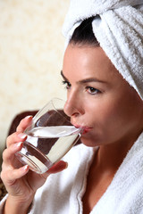 woman in towel drinking water