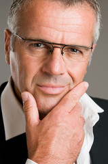 Pensive satisfied mature man