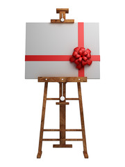 Wooden easel with blank canvas with red ribbon isolated