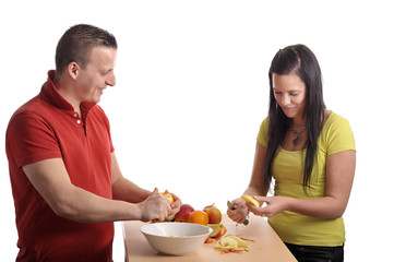 young couple preparing a fruit salad
