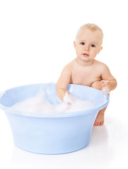 The little boy bathes in a bath