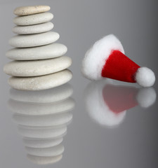 Group of small stones with Santa's cap with reflection