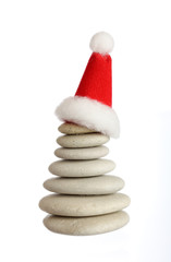 Group of small stones with Santa's cap isolated on white