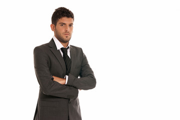 Young businessman with copy-space looking serious arms crossed