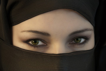 Naklejka premium The woman in a black Muslim scarf