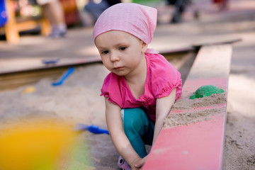 little girl in sandbox