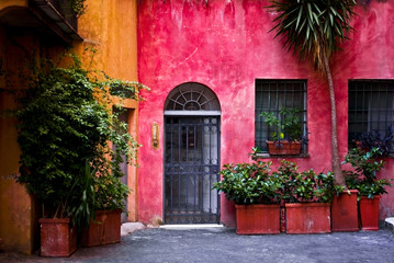 Fototapeta na wymiar Facade of a colorful house in Rome (Italy)