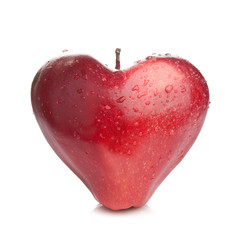 Heart shaped red wet apple on white background